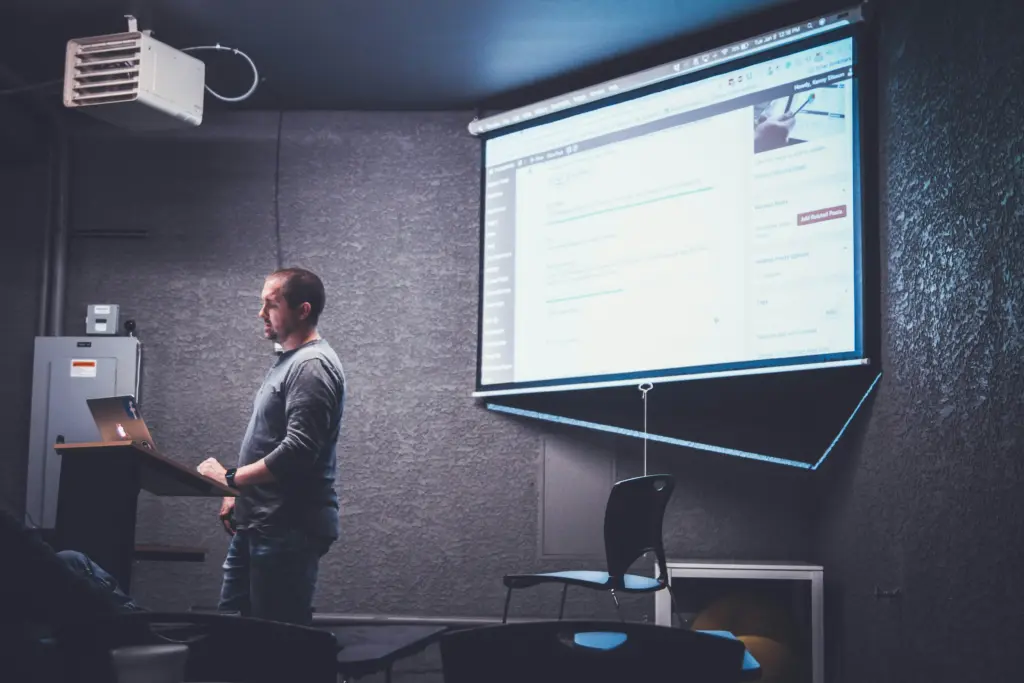 A person conducting a PowerPoint presentation utilizing interactive elements.